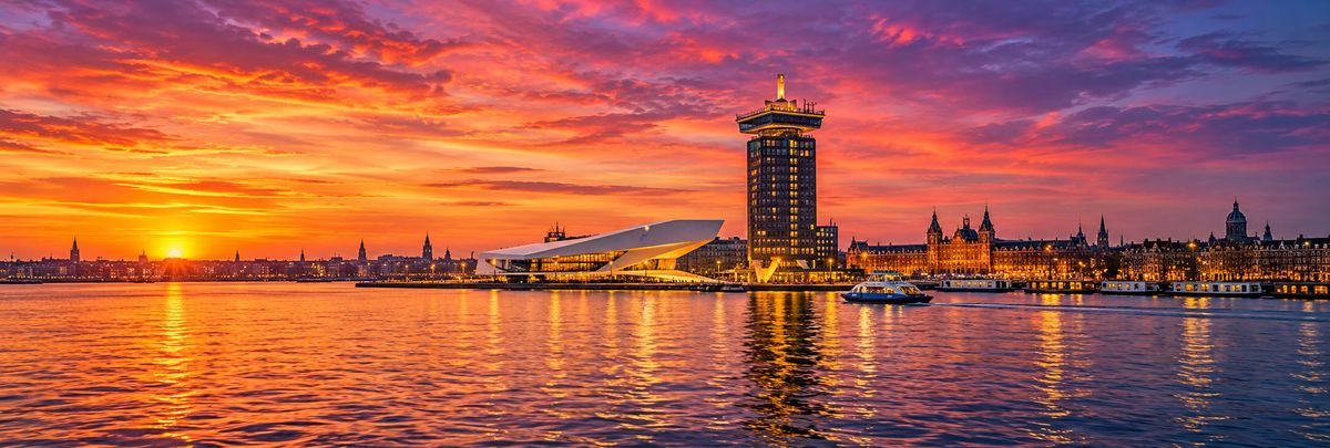 The IJ waterfront in Amsterdam at sunset