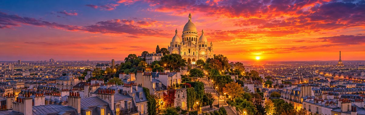 Sacre-Coeur above the rooftops of Paris at sunset